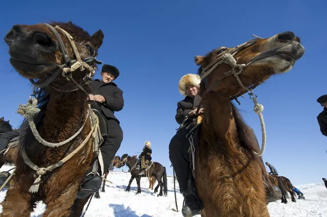 Herders ride horses at a winter festival in Yining, Xinjiang Uighur Autonomous Region, China, January 10, 2016. (Photo by Reuters/China Daily)