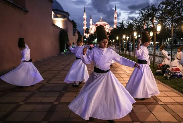 Whirling dervish children practise as they wait to perform at the Blue Mosque Square in Istanbul, Turkey, 30 September 2023. About 750 whirling dervishes took part in the event in front of the Hagia Sophia Mosque, marking the 750th death anniversary of Mevlana Jalaluddin al-Rumi, a 13th-century Sufi mystic, poet and Islamic scholar, who is buried in Turkey's central province of Konya, where he lived most of his life. (Photo by Erdem Sahin/EPA)