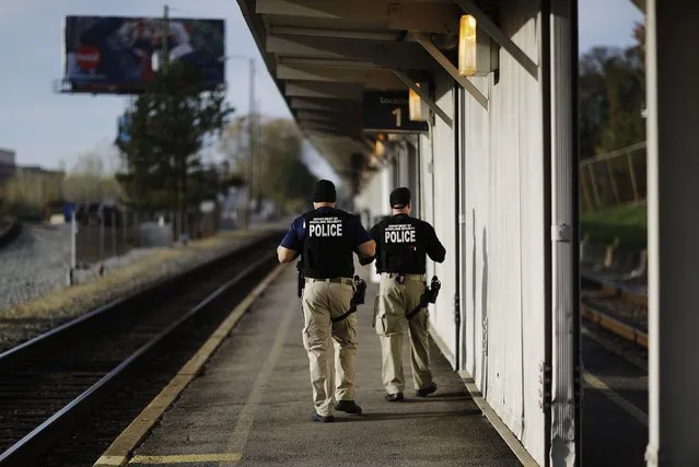 Department of Homeland Security officials patrol along a platform while waiting for a train to New Orleans to arrive in Atlanta, Wednesday, November 23, 2016. Almost 49 million people are expected to travel 50 miles or more for the Thanksgiving holiday, the most since 2007, according to AAA. (Photo by David Goldman/AP Photo)