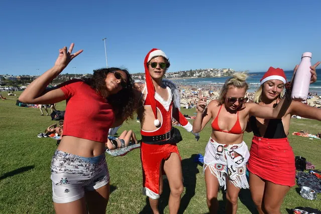 Tourists from Finland celebrate Christmas at Bondi Beach in Sydney, Australia, 25 December 2018. (Photo by Mick Tsikas/EPA/EFE)