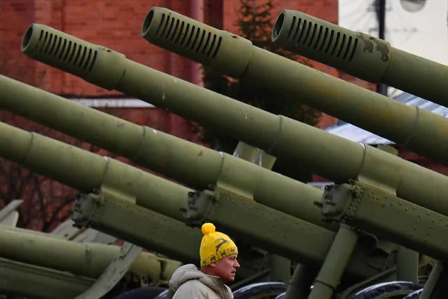 A man walks by artillery gun barrels as he visits an exhibition of military equipment and weapons at the Military Historical Museum of Artillery, Engineering and Communications Forces in Saint Petersburg, on November 19, 2023, as Russia celebrates its Day of Missile Forces and Artillery. (Photo by Olga Maltseva/AFP Photo)