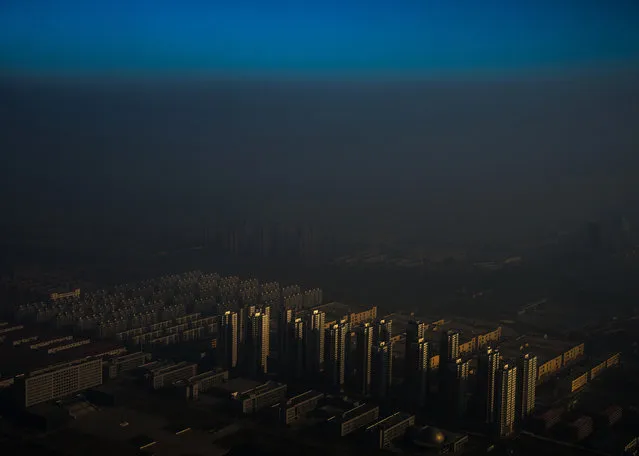 In this image released by World Press Photo titled “Haze in China” by photographer Zhang Lei which won the first prize in the Contemporary Issues Singles category shows a city in northern China shrouded in haze, Tianjin, China, December 10, 2015. (Photo by Zhang Lei/Tianjin Daily, World Press Photo via AP Photo)