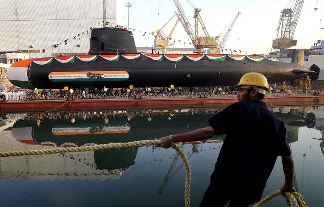 A worker pulls a rope during the launch of Khanderi, India’s second Scorpene class submarine at the Mazagon Dock Shipbuilders Limited in Mumbai, India, Thursday, January 12, 2017. (Photo by Rafiq Maqbool/AP Photo)