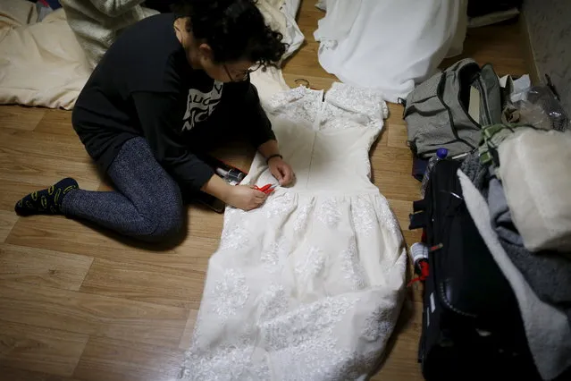 Lee Hee Wolf from U.S. fixes her wedding dress as she prepare for the upcoming mass wedding ceremony of the Unification Church at a resort in Yangpyeong, South Korea, February 19, 2016. (Photo by Kim Hong-Ji/Reuters)