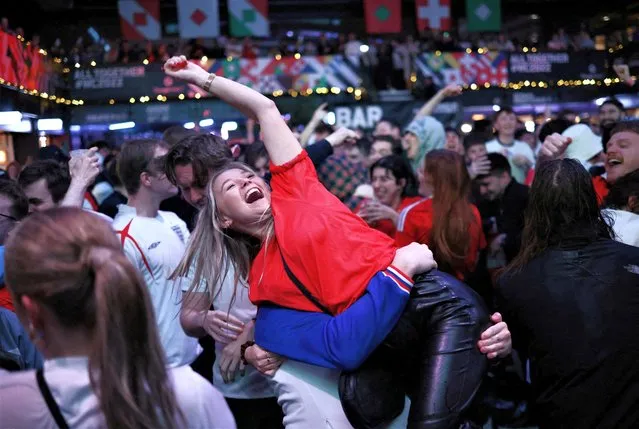 England fans celebrate their side's third goal of the game, scored by England's Marcus Rashford, at BoxPark Wembley, during a screening of the FIFA World Cup Group B match between Wales and England on Tuesday, November 29, 2022. (Photo by Henry Nicholls/Reuters)