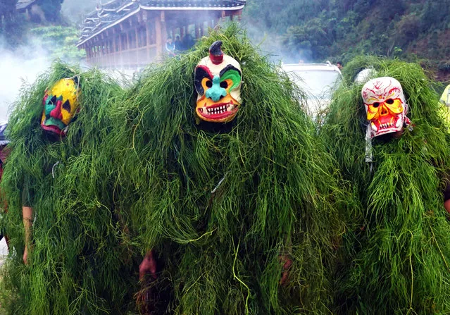 People dressed as “Manghao” attend the annual Manghao Festival at Rong'an County on February 13, 2019 in Liuzhou, Guangxi Zhuang Autonomous Region of China. People of Miao ethnic group dressed up as Manghao applied boiler ash on others for good blessings to celebrate Manghao Festival in Rong'an on Wednesday. Manghao is a god who can drive away the evil and bring people happiness, according to local folklore. (Photo by VCG/VCG via Getty Images)