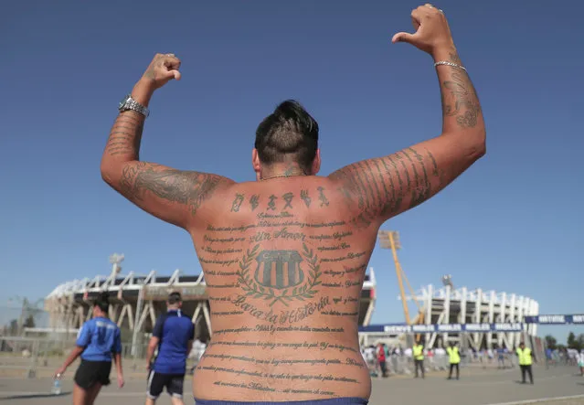 In this Wednesday, February 20, 2019 photo, a fan of Argentina's Talleres soccer team shows off his soccer team related tattoo before attending a Copa Libertadores soccer match against Chile's Palestino in Cordoba, Argentina. (Photo by Nicolas Aguilera/AP Photo)