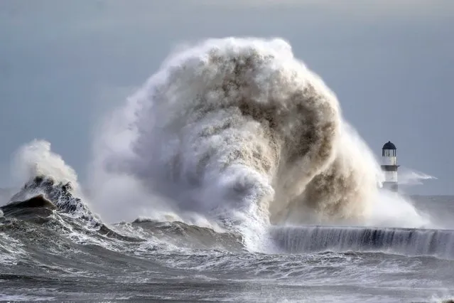 Waves crash against the lighthouse in Seaham Harbour, County Durham in northeast England on Friday, November 24, 2023. (Photo by Owen Humphreys/PA Images via Getty Images)