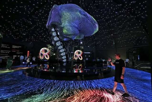A man takes a video inside the Russia pavilion during the first day of the Dubai Expo 2020 in Dubai, United Arab Emirates, Friday, October 1, 2021. (Photo by Kamran Jebreili/AP Photo)