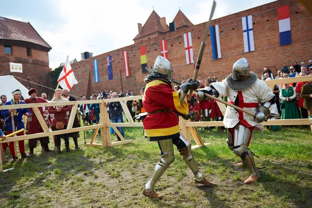 An English knight (R) fights a Spanish knight (L) during the International Medieval Combat Federation World Championship at the Malbork Castle Museum, in Malbork, Poland, 30 April 2015. About 500 fighters representing 30 countries from all over the world are participating in the event running until 03 May. (Photo by Adam Warzawa/EPA)