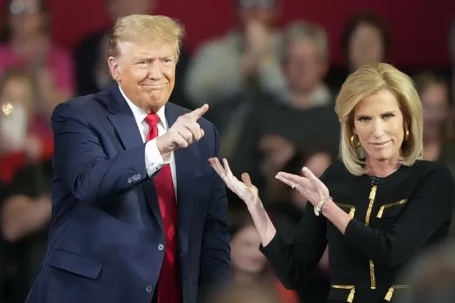 Republican presidential candidate former President Donald Trump and moderator Laura Ingraham gesture on stage during a Fox News Channel town hall Tuesday, February 20, 2024, in Greenville, S.C. (Photo by Chris Carlson/AP Photo)