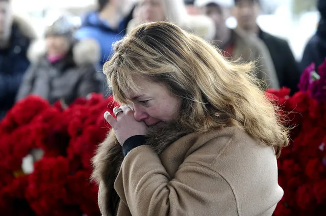 A woman mourns after putting flowers in memory for the victims of the crashed FlyDubai plane at the Rostov-on-Don airport, about 950 kilometers (600 miles) south of Moscow, Russia, Sunday, March 20, 2016. Emergency workers on Sunday finished combing the debris-laden runway of the airport in southern Russia where the plane carrying 62 people crashed before dawn on Saturday. (Photo by AP Photo)