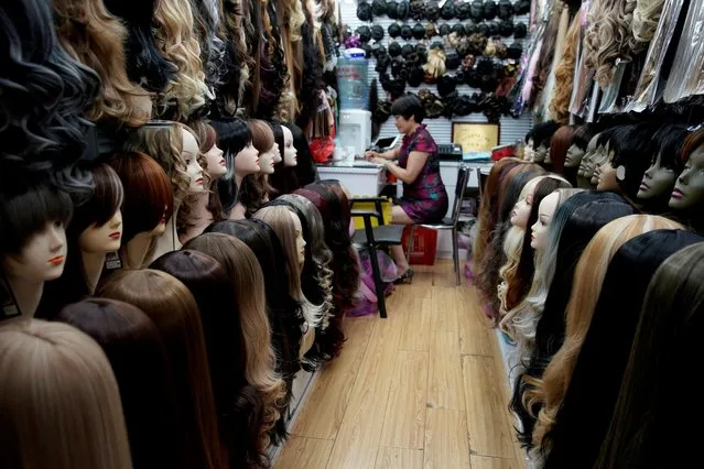 A vendor works on a wig at the Yiwu Wholesale Market in Yiwu, Zhejiang province, China, May 9, 2019. (Photo by /Reuters)