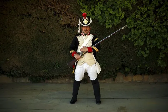 Lisardo Lopez, 49, dressed in early nineteenth century French army uniform poses for a photo as he participates in the third edition of “Ronda Romantica” (Romantic Ronda) in Ronda, southern Spain, May 16, 2015. (Photo by Jon Nazca/Reuters)