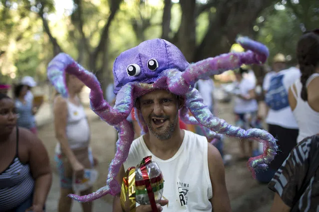 A patient from the Nise da Silveira Mental Health Institute wears an octopus costume during the institute's carnival parade, coined in Portuguese: “Loucura Suburbana”, or Suburban Madness, in the streets of Rio de Janeiro, Brazil, Thursday, February 23, 2017. (Photo by Silvia Izquierdo/AP Photo)