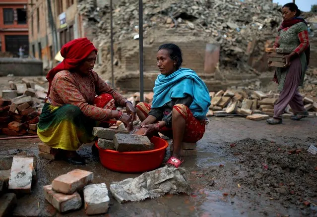 Women wash usable bricks which they found from collapsed houses after the earthquake,  in  Bhaktapur, Nepal, May 19, 2015. (Photo by Ahmad Masood/Reuters)