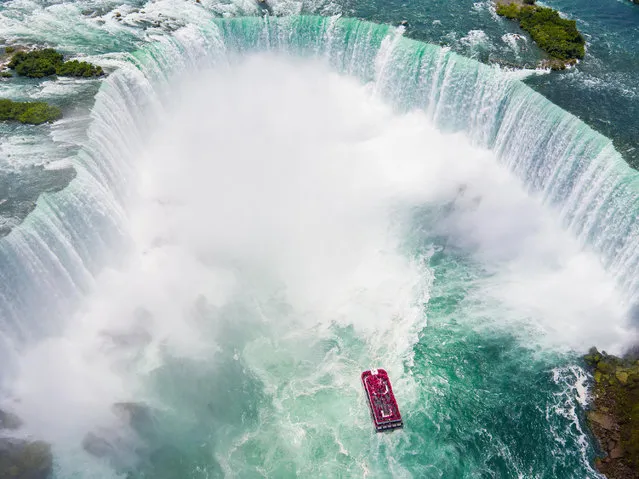 Maid of the Mist journeys through the thundering veil of Horseshoe Falls, a 2,600-foot long waterfall spanning two nations. (Photo by Chase Guttman/Caters News)