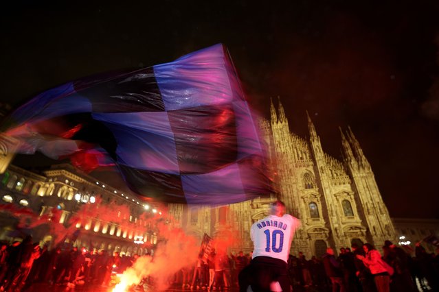 Inter Milan fans celebrate in Piazza Duomo square in front of the gothic cathedral after Inter Milan won the Serie A title against AC Milan in Milan, Italy, Monday, April 22, 2024. (Photo by Antonio Calanni/AP Photo)
