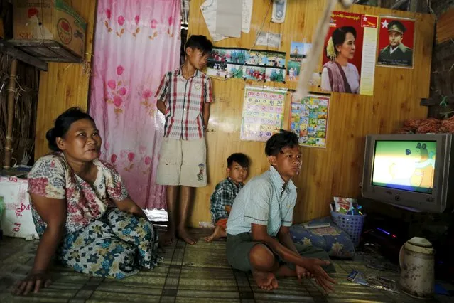 Kyaw Khine Soe (R), 16, sits inside his home with his family outside Yangon, Myanmar February 17, 2016. (Photo by Soe Zeya Tun/Reuters)