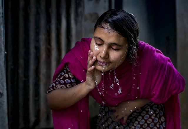 Rani washes her face on March 6, 2017 in Khulna division, Bangladesh. Rani, who is now 16, was under pressure to marry a boy when she was 14-years-old despite the reluctance of Rani and her father, Abdul. When the boy's family, who are politically connected in the area, discovered the relationship, they insisted for the couple to get married. The boy threatened to kill himself while his family said they would kidnap her if she did not agree. The news had spread and arrangements were made after a woman's affairs officer got involved. Two years after the incident, Roni reflects and says, “I lost faith in men. Men can love women but they're not capable of respecting women. For our society for girls to leave the house and talk to boys, it's unacceptable. People gossip and start saying bad things about the girl”. She said the harassment was so bad that she can't walk around her village without wearing a burka. “If I go out without it on sometimes boys and men make rude comments to me, they use really bad words that I can't repeat out loud. If even one corner of my scarf is out of place then boys make bad comments. It happens to my friends all the time”. Rani now spends her time studying and dreams of being a doctor someday. The Bangladesh parliament approved a law last week that permits girls under age 18 to marry under  special circumstances, with permission from their parents and a court without a minimum age for these marriages. Human Rights Watch called the move a “devastating step backward for the fight against child marriage in Bangladesh” as the country has the highest rate of child marriage in Asia, and ranks one of the top in the world with 52 percent of the girls married before age 18, and 18 percent married before age 15. (Photo by Allison Joyce/Getty Images)
