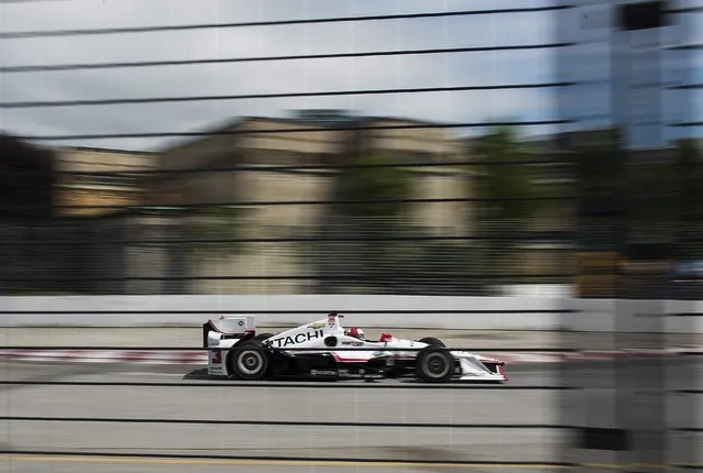 Helio Castroneves, of Brazil, accelerates after a turn during practice for the IndyCar auto race Saturday, June 13, 2015, in Toronto. (Aaron Vincent Elkaim/The Canadian Press via AP)