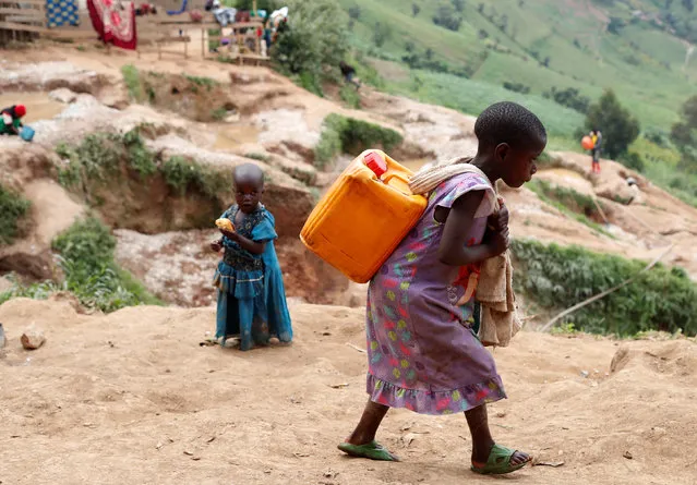 A girl carries a container of water at a coltan mine in Kamatare, Masisi territory, North Kivu Province of Democratic Republic of Congo on December 17, 2018. (Photo by Goran Tomasevic/Reuters)