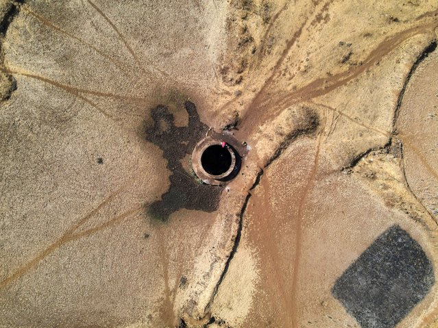 A drone view of a woman drawing water from a parched well in Kasara, India, on May 1, 2024. (Photo by Francis Mascarenhas/Reuters)