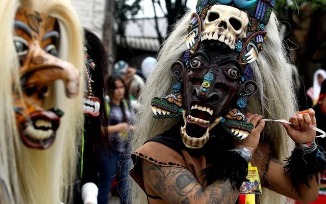 Dancers with masks participate in the “Tastuanes” (an indigenous pre-Columbian word for “leaders”), a Catholic feast in veneration of Santo Santiago (Saint James the Apostle), in Tonala, Jalisco State, Mexico, on July 25, 2019. (Photo by Ulises Ruiz/AFP Photo)