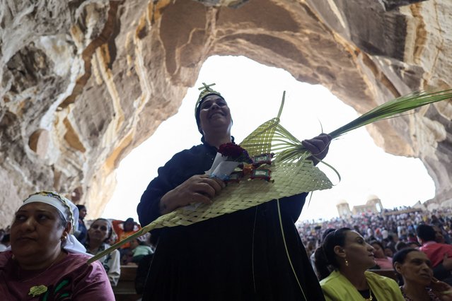 A Coptic Orthodox Christian attends a Palm Sunday mass at the Samaan el-Kharaz Monastery in the Mokattam Mountain area of Cairo, Egypt, on April 28, 2024. (Photo by Amr Abdallah Dalsh/Reuters)