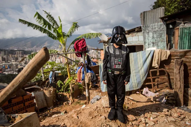 A boy dressed as a Star Wars character Darth Vader, as part of the Carnival celebrations, poses for a photo in the San Miguel neighborhood of the Cota 905 sector, in Caracas, Venezuela, 28 February 2017. (Photo by Miguel Gutierrez/EPA)