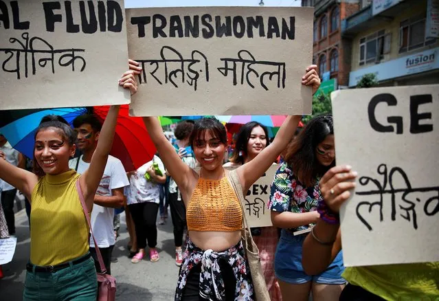 Participants hold up placards while taking part in a Gay Pride parade to mark pride month in Kathmandu, Nepal, June 29, 2019. (Photo by Navesh Chitrakar/Reuters)