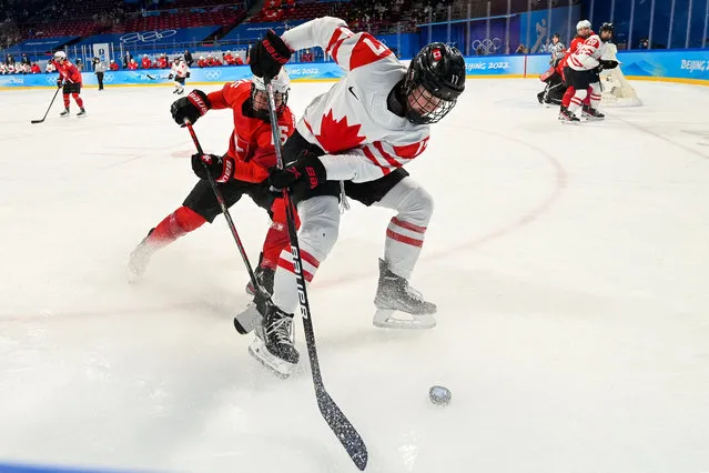 Canada's Ella Shelton (R) and Switzerland's Laura Zimmermann fight for the puck during the women's play-offs semifinal match of the Beijing 2022 Winter Olympic Games ice hockey competition between Canada and Switzerland, at the Wukesong Sports Centre in Beijing on February 14, 2022. (Photo by Gabriel Bouys/AFP Photo)