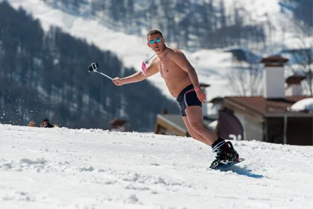 A man dressed in a swimsuit participates in the BoogelWoogel alpine carnival at the Rosa Khutor Alpine Resort in Krasnaya Polyana, Sochi, Russia on April 1, 2017. (Photo by Artur Lebedev/TASS)