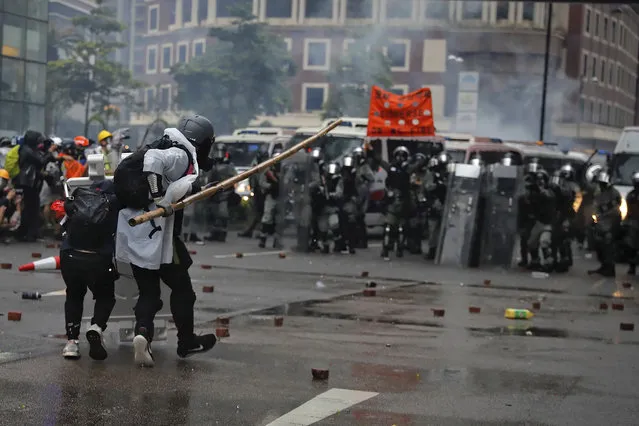 Protesters use bamboo sticks as they face riot police during a protest in Hong Kong, Sunday, August 25, 2019. Police were skirmishing with protesters in Hong Kong for a second straight day on Sunday following a pro-democracy march in an outlying district. (Photo by Kin Cheung/AP Photo)