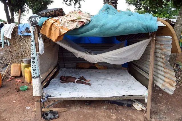 A baby sleeps on a makeshift bed at a camp set up for Muslims waiting to be evacuated near the mosque of the PK 12 district of Bangui on April 22, 2014. The United Nations has evacuated almost 100 Muslims from the capital of the crisis-torn Central African Republic to “save their lives”, according to officials. (Photo by Issouf Sanogo/AFP Photo)