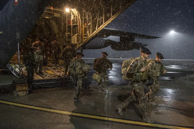This photo provided by the French Army shows French soldiers leaving in a cargo plane as French troops arrive in Constanta, a Black Sea port, eastern Romania, Monday, February 28 2022. France announced last Friday it will deploy 500 troops with armored vehicles as part of NATO forces to Romania after Russia's invasion of neighboring Ukraine. (Photo by French Army via AP Photo)