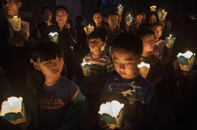 Chinese Catholics hold candles at a mass on Holy Saturday during Easter celebrations at the government sanctioned West Beijing Catholic Church on April 15, 2017 in Beijing, China. China, an officially atheist country, places a number of restrictions on Christians, allowing legal practice of the faith only at state-approved churches. The policy has driven an increasing number of Christians and Christian converts 'underground' to congregations in private homes and other venues. While the size of the religious community is difficult to measure, studies estimate there are more than 80 million Christians inside China; some studies support the possibility it could become the most Christian nation in the world in the coming years. Officially there have been no relations between China and the Vatican since the country's modern founding in 1949 though in recent years there have been signs of warming relations between Chinese president Xi Jinping and Pope Francis that could possibly allow greater religious freedom in the future. At present, the split means approved Chinese Christians worship within a state-sanctioned Church known as the Patriotic Association which regards the Communist Party as its leader, not the Pope in Rome. (Photo by Kevin Frayer/Getty Images)
