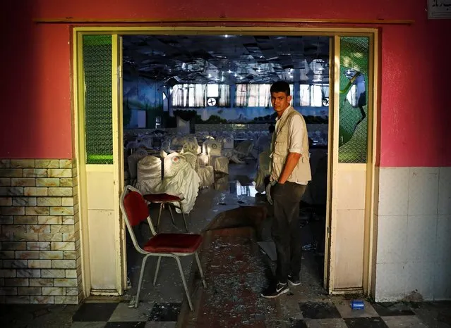 An Afghan man inspects a damaged wedding hall after a blast in Kabul, Afghanistan on August 18, 2019. (Photo by Mohammad Ismail/Reuters)