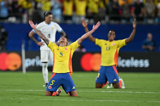 Colombia's midfielder #05 Kevin Castano and Colombia's defender #13 Yerry Mina celebrate their team's victory in the Conmebol 2024 Copa America tournament semi-final football match between Uruguay and Colombia at Bank of America Stadium, in Charlotte, North Caroline on July 10, 2024. (Photo by Chandan Khanna/AFP Photo)