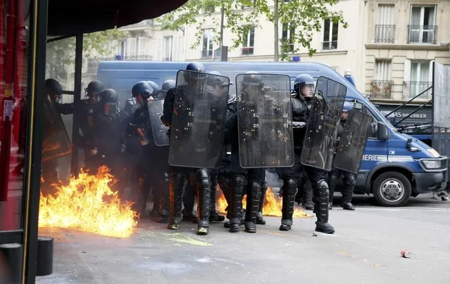 French gendarmes gather together during clashes with protestors at a demonstration against  French labour law reforms in Paris, France, May 17, 2016. (Photo by Gonzalo Fuentes/Reuters)
