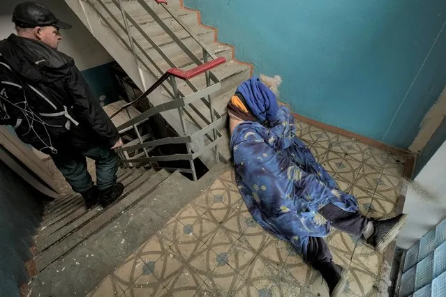 The lifeless body of a man lies in the staircase of a building in Bucha, Ukraine, Sunday, April 3, 2022. (Photo by Vadim Ghirda/AP Photo)