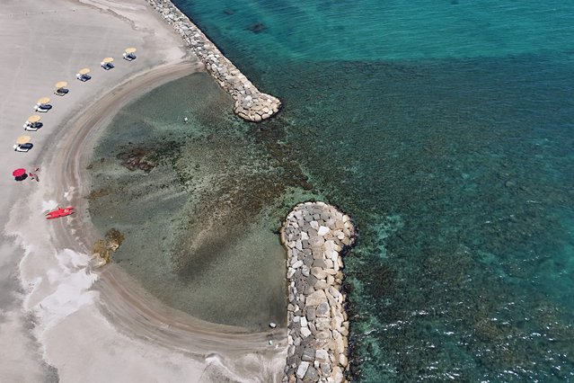 An aerial view shows the beach of luxury hotel La Posta Vecchia in Marina di San Nicola, a short distance from Ladispoli, on 11 July, 2024. (Photo by Andreas Solaro/AFP Photo)