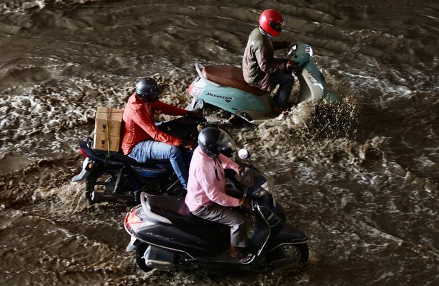 Motorists drive through the water logged street following a heavy rain, in Bangalore, India, 12 August 2024. Bangalore is experiencing heavy downpour leading to water logging across different part of the city and recorded minimum temperature of 21 degrees Celsius and humidity of around 98 percent. The Indian monsoon season takes place between June to September. (Photo by Jagadeesh N.V./EPA/EFE)