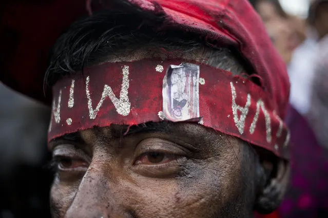 A man with his face coated motor oil, takes part in the festivities in honor of Santo Domingo de Guzman in Managua, Nicaragua, Saturday, August 1, 2015. (Photo by Esteban Felix/AP Photo)