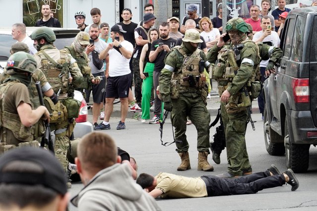 Members of Wagner group detain a man in the city of Rostov-on-Don, on June 24, 2023. President Vladimir Putin on June 24, 2023 said an armed mutiny by Wagner mercenaries was a “stab in the back” and that the group's chief Yevgeny Prigozhin had betrayed Russia, as he vowed to punish the dissidents. Prigozhin said his fighters control key military sites in the southern city of Rostov-on-Don. (Photo by AFP Photo/Stringer)