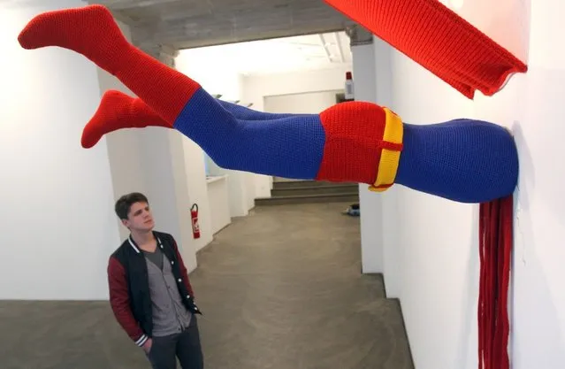 The knitted sculpture 'Superman' by Patricia Waller, featuring the comic book character meeting death by his own superhuman ability to fly, hangs in the 'Broken Heroes' exhibition at the Deschler Gallery