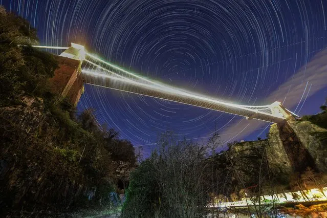 An overlay image of 350 photographs shows the circumpolar star and aircraft trails above Clifton Suspension Bridge in Bristol, United Kingdom on January 6, 2022. (Photo by Lee Thomas/The Times)