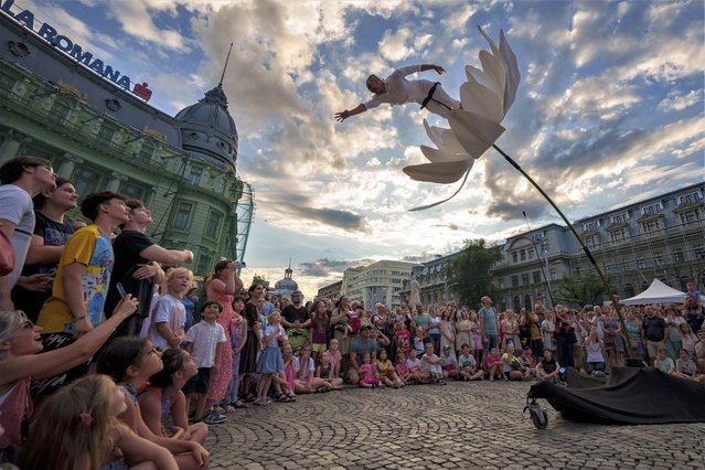 Artists of Italy's Flower Sway Poles perform during the B-FIT in the Street international festival in Bucharest, Romania, Sunday, July 2, 2023. The street theater festival took place over the weekend in the Romanian capital. (Photo by Andreea Alexandru/AP Photo)