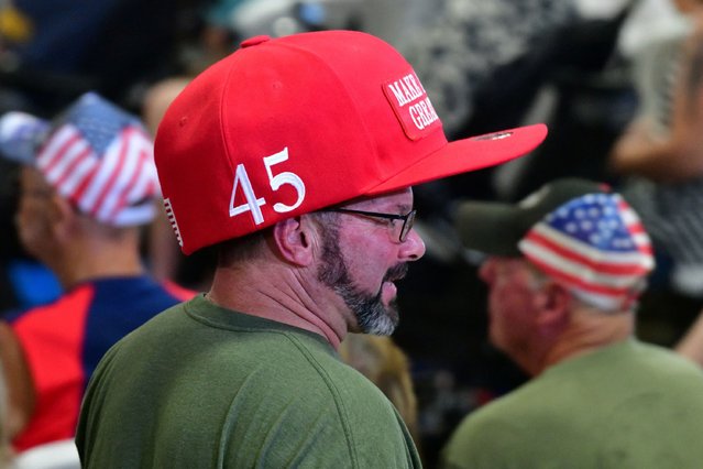 A supporter wears a large MAGA hat before listening to Republican vice presidential nominee Senator JD Vance in Tucson, Arizona on October 22, 2024. (Photo by Caitlin O'Hara/Reuters)