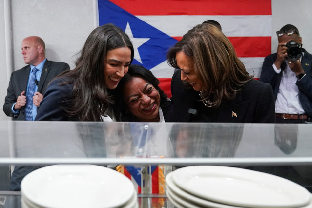 Democratic presidential nominee U.S. Vice President Kamala Harris, and U.S. Rep. Alexandria Ocasio-Cortez (D-NY), embrace Diana de la Rosa, owner of the Old San Juan Cafe, during a campaign stop in Reading, Pennsylvania, U.S., November 4, 2024. (Photo by Kevin Lamarque/Reuters)